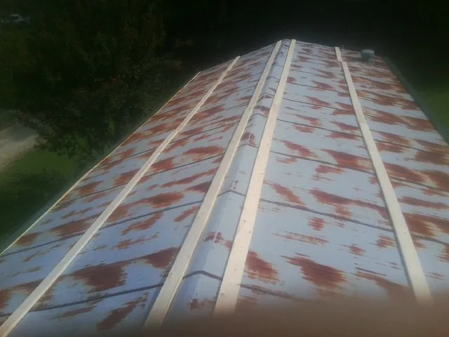 Rusted metal roof panels with new wood purlins before replacement — Storm Damage Roof Repair in Badin by Roofing Brothers